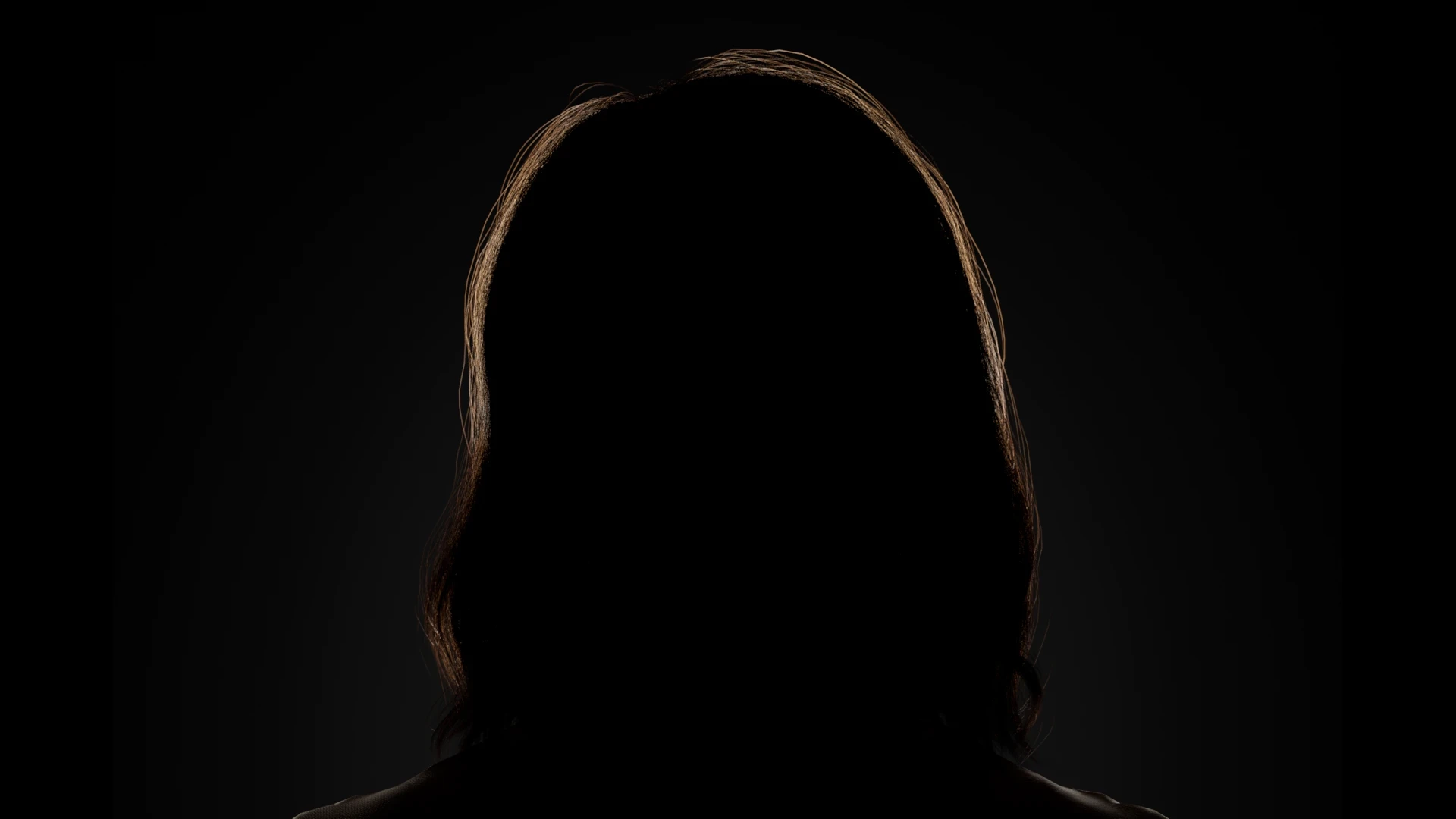 CG figure front on, reduced to a silhouette with only a warm rim tracing the hair
