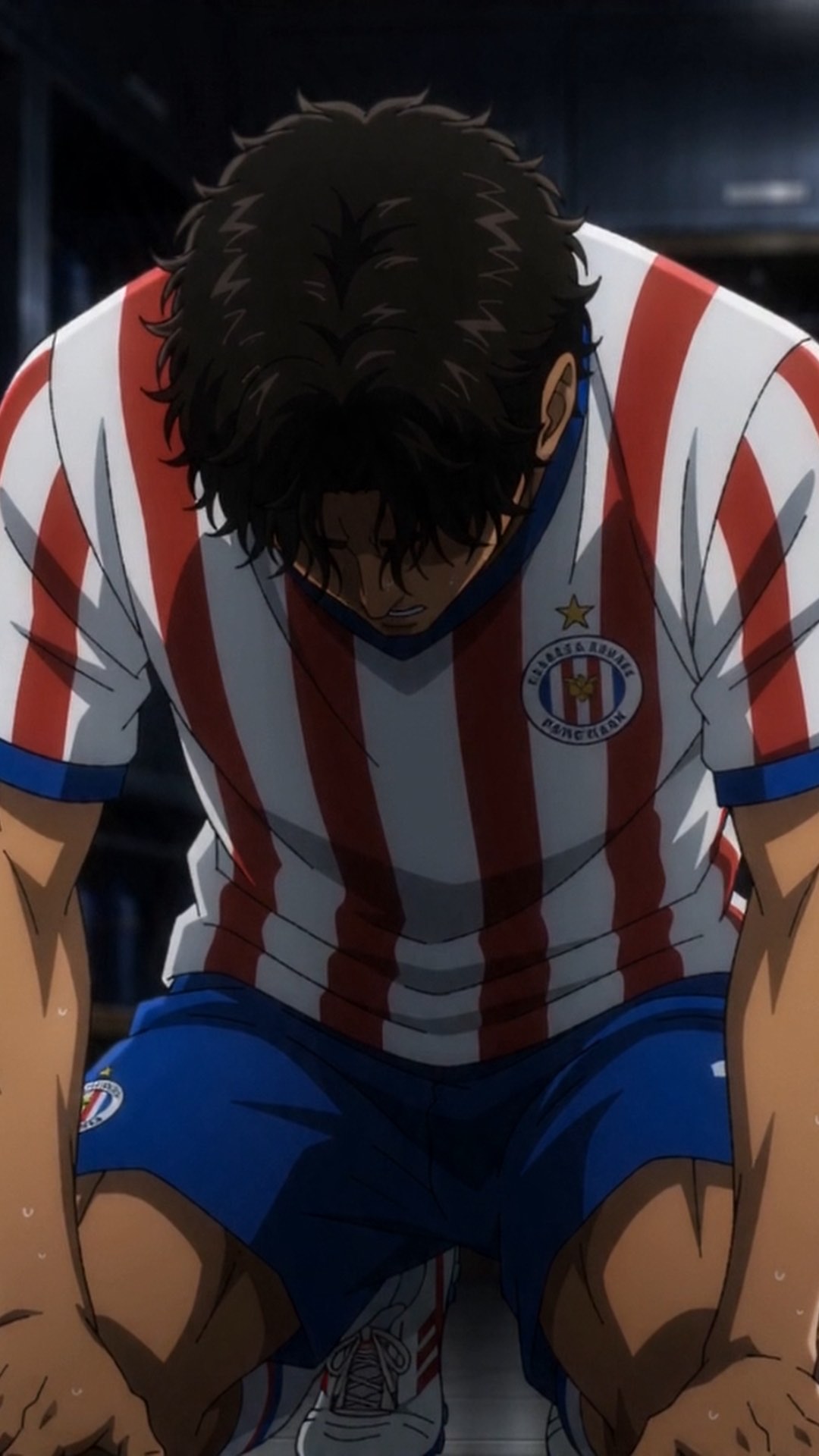 Anime still — a player doubled over on the bench in the red and white striped Paraguay kit