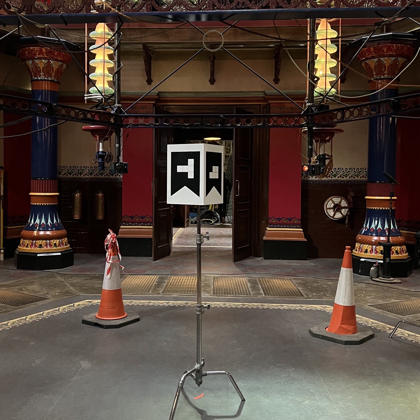 The calibration cube on a stand at the centre of the set, an ArUco marker printed on each visible face