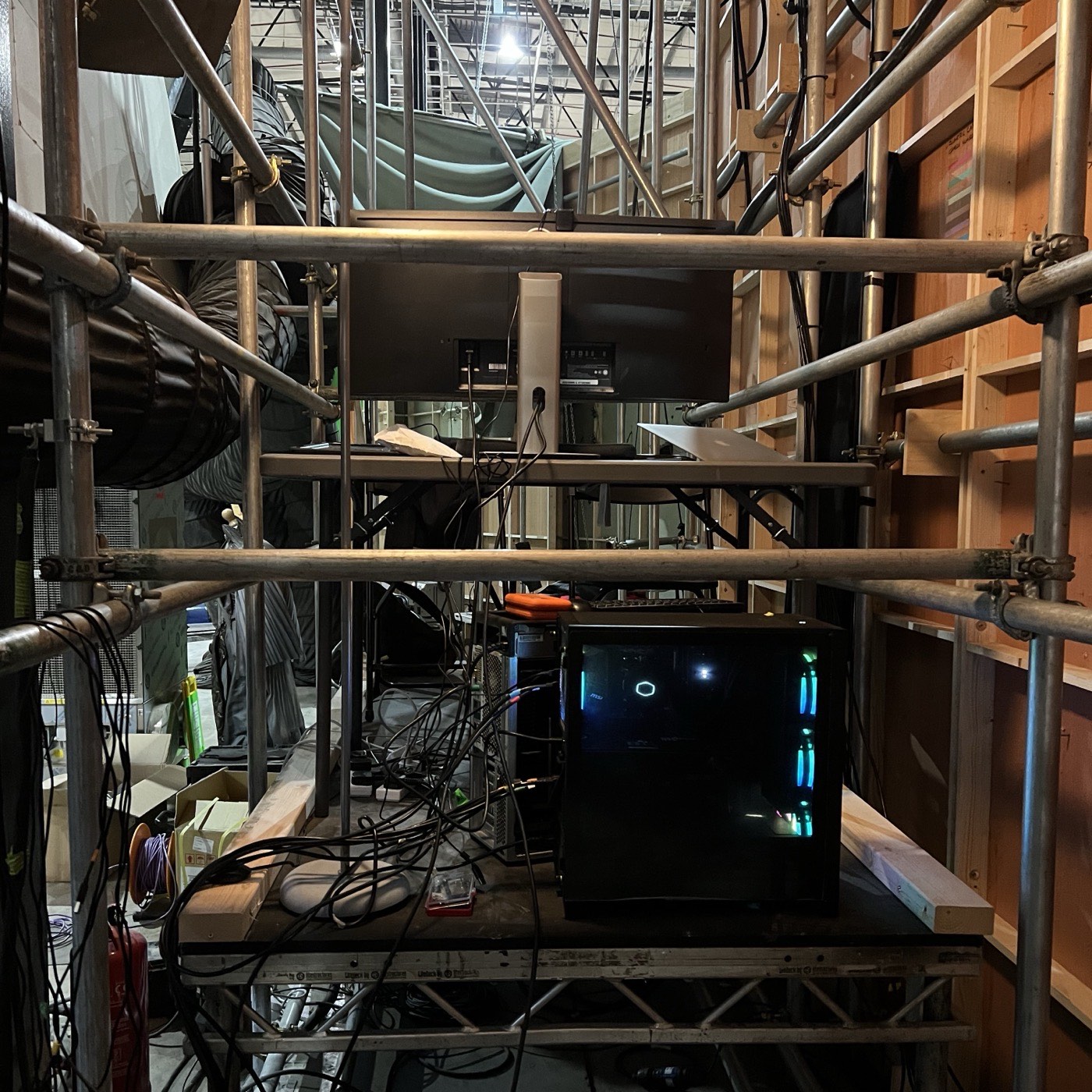 The workstation driving the camera array, sitting on scaffolding behind the set among cable runs