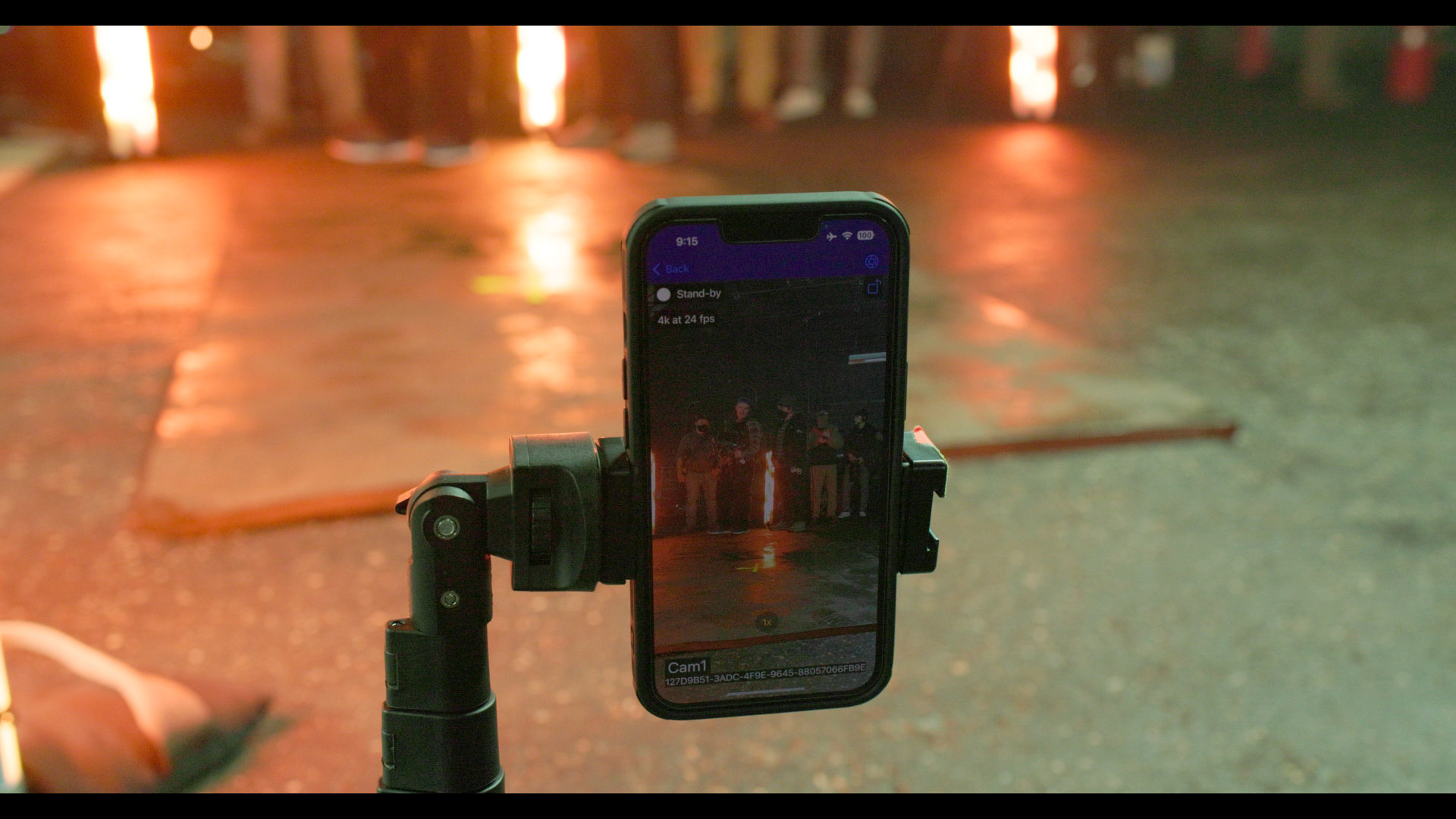 An iPhone clamped into a rig mount, its screen showing the take and the camera's assigned number
